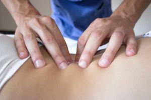 osteopath hands on patient back